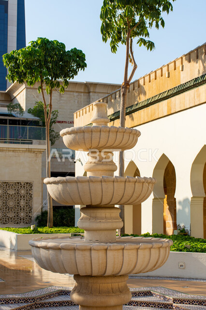 Andalusian style water fountain design for a restaurant in Dubai, distinctive decorations and engineering designs, traditional historical architecture, interest in planting trees and green plants, tourist places and landmarks in the United Arab Emirates