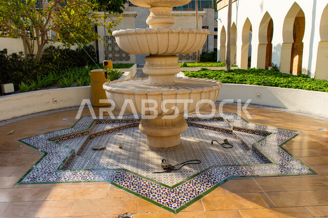Andalusian style water fountain design for a restaurant in Dubai, distinctive decorations and engineering designs, traditional historical architecture, interest in planting trees and green plants, tourist places and landmarks in the United Arab Emirates
