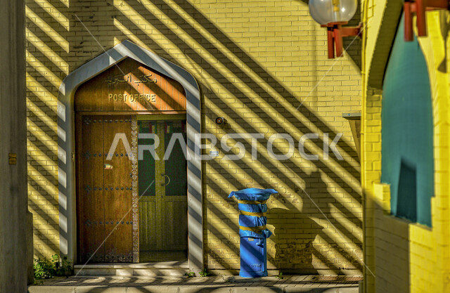 Sun shadows on the wall of the post office in an old popular market in Kuwait City, Post office