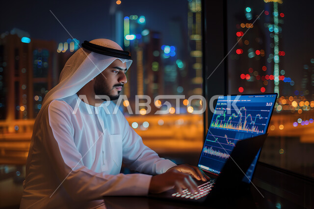 Managing daily work tasks at company headquarters, Saudi jobs and professions, using modern technical devices, close-up of a Saudi Arabian Gulf man wearing traditional dress sitting in his office working on a laptop