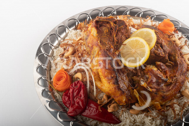Popular rice dish with dazzling meat prepared in Saudi kitchen, meat sacrifice, Saudi folk food, decorated traditional Saudi dish, ready-made traditional Saudi kitchen, white background