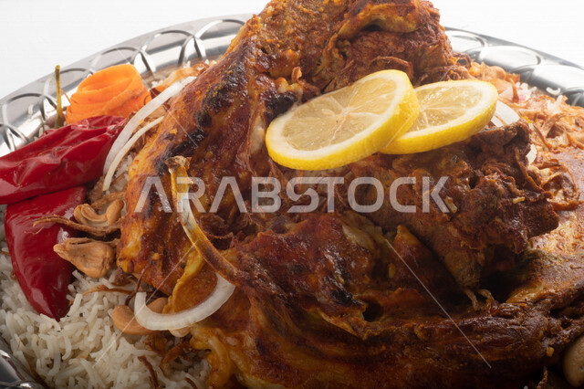 Popular rice dish with dazzling meat prepared in Saudi kitchen, meat sacrifice, Saudi folk food, decorated traditional Saudi dish, ready-made traditional Saudi kitchen, white background