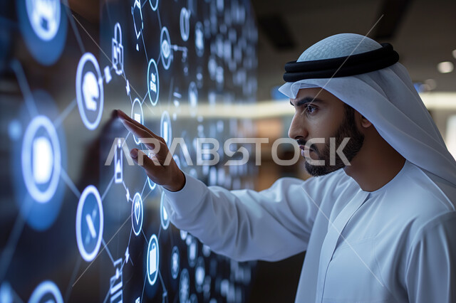 Using modern electronic technologies, a close-up image of a Saudi Arabian Gulf man wearing a traditional thobe touching illuminated holographic icons and symbols on electronic screens, the concept of growth and technological progress in the Kingdom of Saudi Arabia