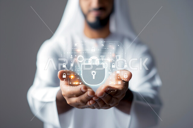 Technological growth and progress, use of modern electronic technologies, close-up portrait of a Saudi Arabian Gulf man raising his hands interacting with a 3D illuminated lock icon, holographic symbols and elements, concept of data protection, gray background