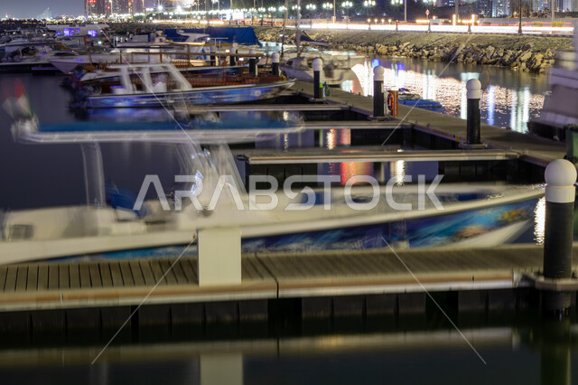 Famous tourist attractions in the Emirate of Dubai, the waterfront on the coast of the Arabian Gulf, the marina of yachts and ships in the sea, recreational activities in the summer