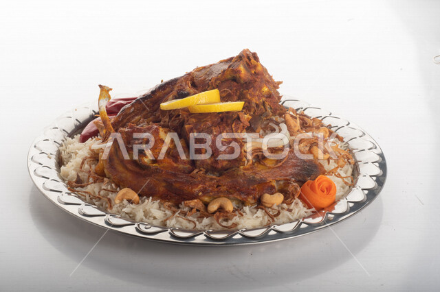 Popular rice dish with dazzling meat prepared in Saudi kitchen, meat sacrifice, Saudi folk food, decorated traditional Saudi dish, ready-made traditional Saudi kitchen, white background