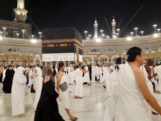 A group of pilgrims in the Grand Mosque in Mecca, performing Hajj and Umrah rituals, sacred Islamic religious places and landmarks in the Kingdom of Saudi Arabia, the fifth pillar of Islam, visiting the Holy House of God in Mecca