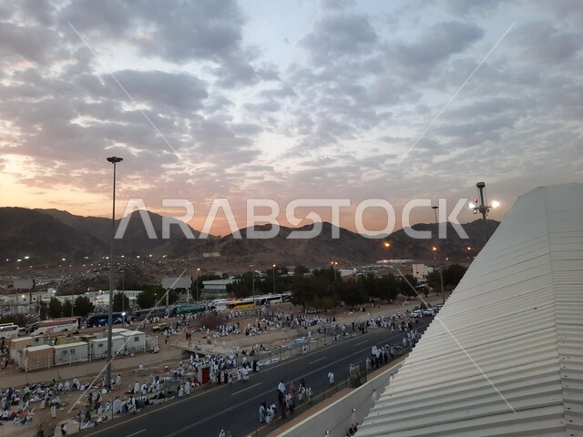 Performing Hajj and Umrah rituals, worshiping and getting closer to God in sacred Islamic religious landmarks and places, pilgrims of the Sacred House of God in Muzdalifah wearing the Ihram dress in Mecca in the Kingdom of Saudi Arabia