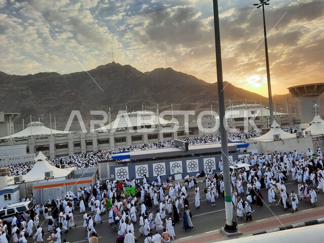 Performing Hajj and Umrah rituals at sunset, pilgrims to the House of God in Muzdalifah wearing Ihram clothes in Mecca, Saudi Arabia, worship and drawing closer to God in Islamic religious holy sites and places
