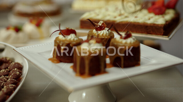 Delicious candy pieces, a plate of cheesecake dessert decorated with berries and caramel, oriental dessert, Ramadan sweets and sugars, dessert and delicious cold desserts.
