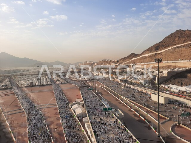 A group of pilgrims heading to the Jamarat Bridge in Mecca, visitors to the House of God perform Hajj and Umrah rituals, sacred Islamic religious places and landmarks in the Kingdom of Saudi Arabia, visiting the Kaaba
