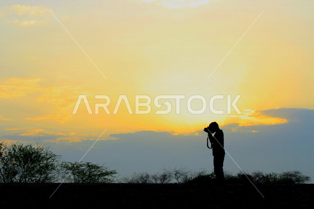 scenic aesthetic silhouette of orange sunset and sunrise with silhouette character creative sunset and sunrise of the desert scenic desert nature beauty at sunset and sunrise time