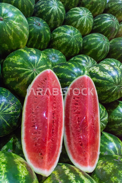 فاكهة البطيخ الأحمر بسوق الخضار والفواكه بمنطقة الديرة بمدينة دبي بالإمارات، خضار وفواكه طازجة، المحاصيل الزراعية والمنتجات المحلية، الفاكهة الموسمية الصيفية الطازجة ، صورة مقربة لحبات وشرائح البطيخ الأحمر الصحي والشهي، الأسواق الشعبية لبيع الخضراوات والفواكه