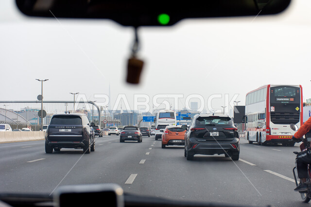 Vehicles during the day on the roads of the United Arab Emirates, means of transportation, cars on the way from Sharjah to Dubai, congestion at peak time