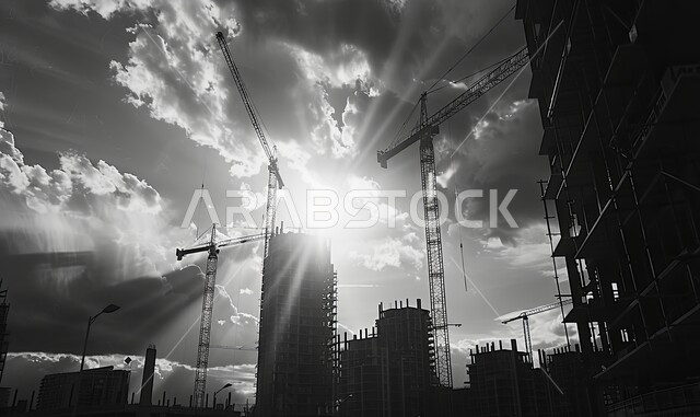 Concept of structural and architectural engineering, implementation of construction plan and formation of metal structure, construction works, pouring concrete and laying foundations, heavy machinery and equipment, cranes and high scaffolding, black and white image of a building under construction in the Kingdom of Saudi ArabiaConcept of structural and architectural engineering, implementation of construction plan and formation of metal structure, construction works, pouring concrete and laying 