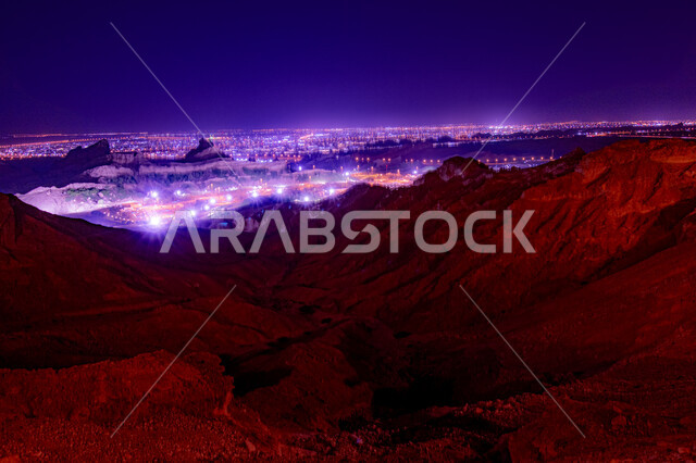 Buildings and architectural development in Al Ain city in Abu Dhabi, United Arab Emirates, historical landmarks, city lights at night, street and road lighting