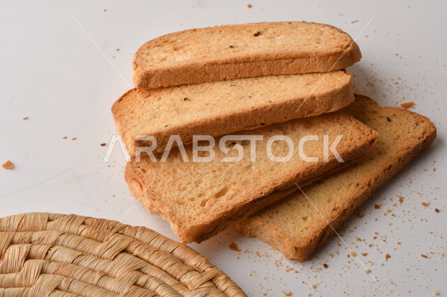 مجموعة من نباتات القمح ، صورة مقربة لشرائح خبز التوست المحمصة على خلفية بيضاء