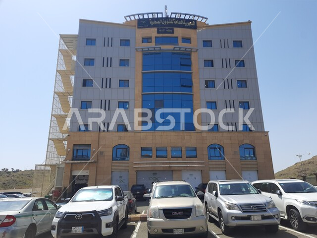Modern and advanced architectural engineering art for building medical facilities and centers, a picture from below of the Directorate of Health Affairs in Al-Baha city, advanced buildings to provide services and care for patients, development and urban progress in the Kingdom of Saudi Arabia