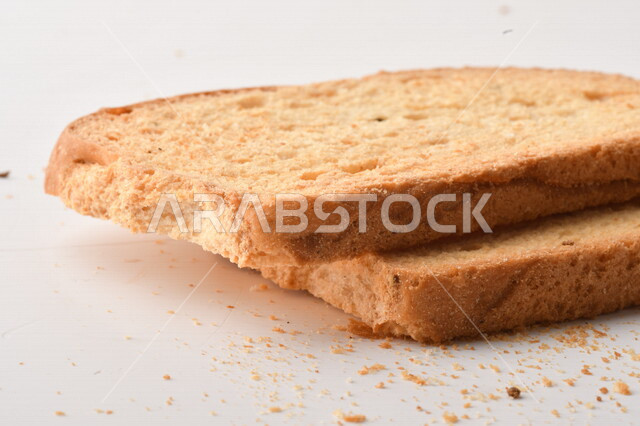 مجموعة من نباتات القمح ، صورة مقربة لشرائح خبز التوست المحمصة على خلفية بيضاء