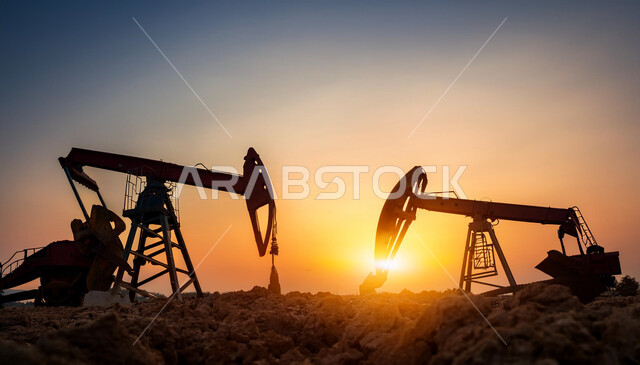 حفارة تقوم بالتنقيب عن النفط في الصحراء في وقت غروب الشمس, استيراد وتصدير الثروات الباطنية، جودة الأدوات والمعدات لصناعة وتخزين البترول، رافعات وآلات حفر ضخمة لاستخراج الزيوت