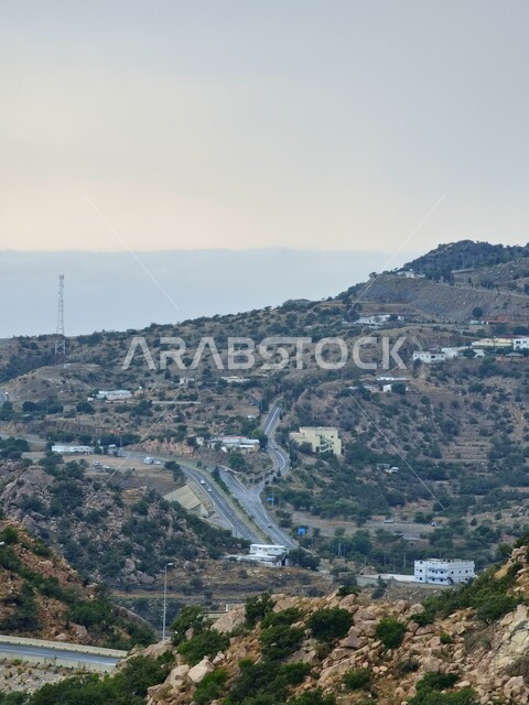 Urban and civilized growth and development of Saudi cities, traffic movement in the streets and connecting nodes in the Kingdom, the movement of cars and fast vehicles on the roads, means of public and private transportation, paved asphalt roads in the city of Taif, green nature and topography of the mountain ranges