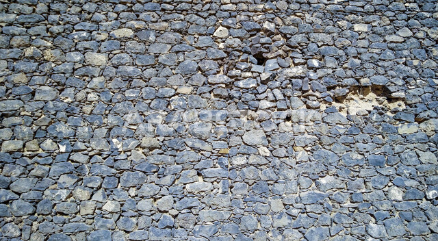 صورة خلفية لجدار حجري قديم بارز الشكل