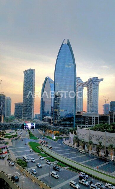 Architectural engineering art of buildings and facilities in the United Arab Emirates, urban growth and development of towers and skyscrapers, famous tourist attractions in Dubai, traffic movement in the streets during the day, interest in planting green plants on the sides of the roads