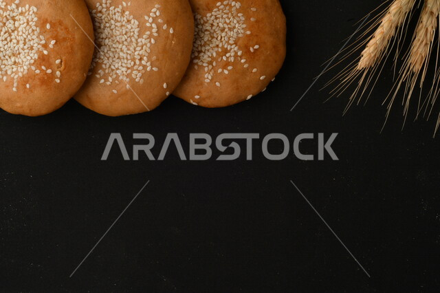 Close up of a group of wheat plants, crispy and crunchy wheat biscuits on a black background
