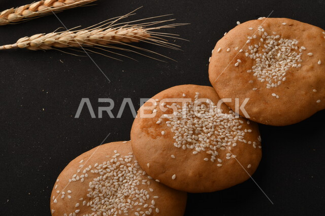 Close up of a group of wheat plants, crispy and crunchy wheat biscuits on a black background