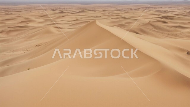  Dry and harsh weather in arid lands, soft golden sand and dunes in the desert of Saudi Arabia, sandy environment during daytime, plateaus and hills in desert landscapes, nature background