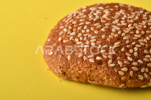 Image of crispy and crunchy wheat biscuits on a yellow background, close-up of delicious wheat biscuits