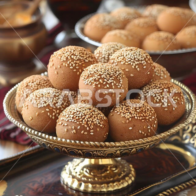 Fresh popular pastries, puff pastry pieces decorated with sesame seeds, a variety of easy and quick pastries and delicious foods, Saudi Arabian Gulf bakeries, a healthy and delicious breakfast table