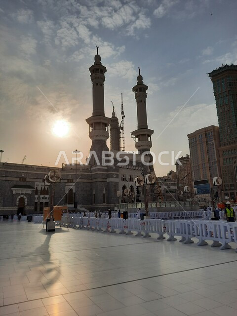 الفناء الخارجي للمسجد الحرام في وقت الغروب، الفن الهندسي المعماري في بناء المآذن الشامخة على الطراز الإسلامي، ساحات الحرم المكي الشريف الخارجية في مكة المكرمة بالمملكة العربية السعودية، أداء مناسك الحج والعمرة، معالم دينية إسلامية مقدسة، أماكن العبادة والطاعة
