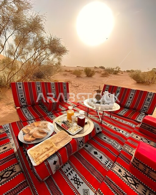 Traditional Arabic sessions, a dining table in the middle of the desert, relaxation and enjoyment in the calm atmosphere, spending a pleasant vacation in the wilderness of the Kingdom of Saudi Arabia, a trip and a wild outing in the desert areas