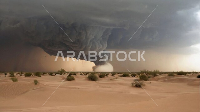 A windstorm hits the desert, a whirlwind of sand flying in the air, the sandy and mountainous nature of the Kingdom, the stormy, raging atmosphere laden with dust and dirt in the deserts of Saudi Arabia