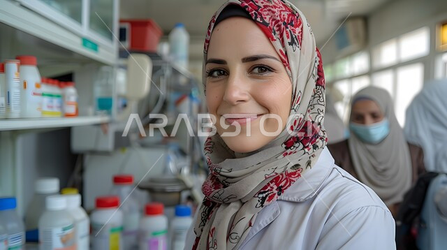 Using sterile glass tubes to analyze different samples, pharmaceutical industry laboratory, medical testing and chemical analysis laboratories, close-up image of a smiling Saudi Arabian Gulf laboratory girl wearing a medical coat conducting experiments and scientific research through biotechnology
