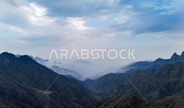Calmness and peace in the peaks and heights, fog and clouds between the mountains in the Asir region in southern Saudi Arabia, the view of the sky full of clouds, famous tourist places and landmarks