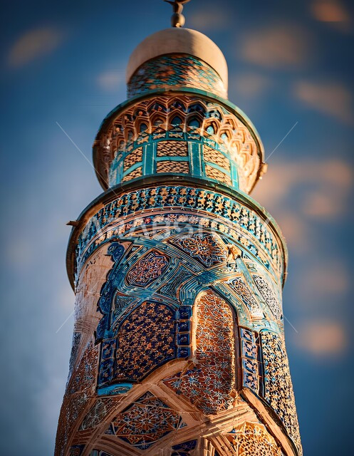 The concept of worship and drawing closer to God Almighty, elegant designs and decorations of mosques in the Kingdom of Saudi Arabia, architectural art of an ancient decorated Arab mosque, close-up of the engravings and decorations on the outer walls of the minaret