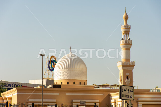 A mosque with a distinctive geometric shape in the city of Dubai, places of worship and closeness to God Almighty, the dome and minaret of the mosque, architectural art in the United Arab Emirates, Islamic tourist attractions