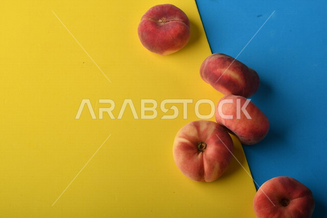 Image of delicious peach fruit on yellow and blue colorful background, delicious healthy peach fruit, summer fruit