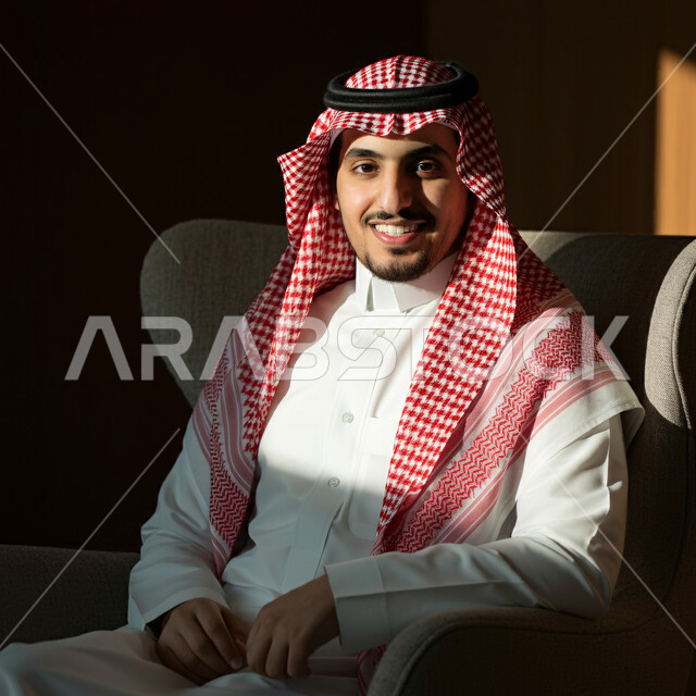 The concept of prestige and masculinity, elegance and interest in external appearance, close-up portrait of a Saudi Arabian Gulf man wearing traditional folk costume looking at the camera with expressions of pleasure and self-confidence, black background