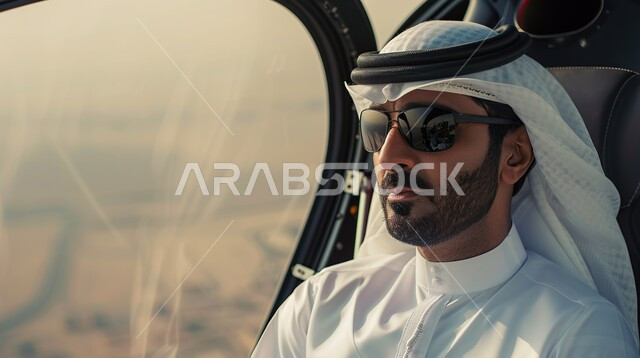مفهوم الرجولة والثقة بالنفس، الاهتمام بالأناقة والمظهر الخارجي، صورة مقربة لرجل عربي خليجي سعودي يرتدي الغترة مع النظارات الشمسية والثوب التقليدي يجلس داخل طائرة مروحية