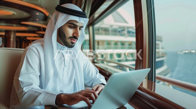Using modern devices to accomplish tasks, a Saudi Arabian Gulf man wearing traditional thobe and shemagh sitting in the office working on his laptop, integrating advanced technologies into daily life