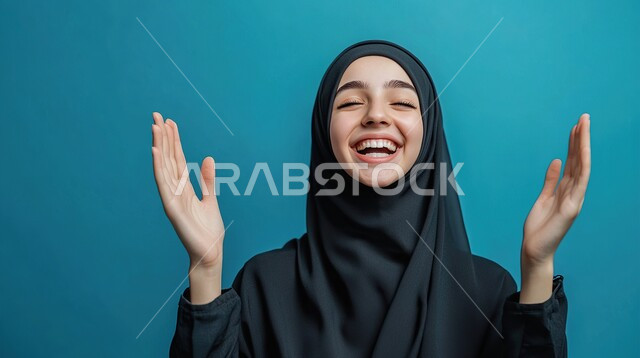 الاسترخاء والشعور بالراحة، الاستمتاع في قضاء الوقت بالتأمل، التدرب على الهدوء وتمالك النفس، المحافظة على اللياقة والصحة البدنية، بورتريه مقرب لشابة عربية خليجية سعودية تقوم بحركات يد مختلفة، خلفية زرقاء