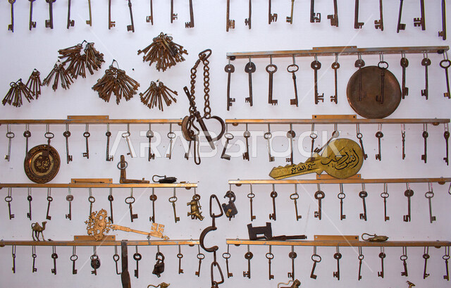 Picture of antique old keys hanging on the wall, key hanger, lock and keys
