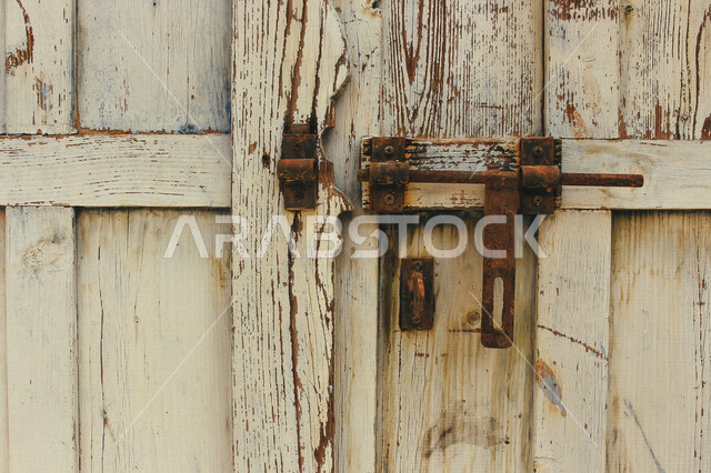 باب آثري قديم في السعودية بأسلوب تاريخي اسلامي ، معالم سياحة في المملكة العربية السعودية ، صورة خلفية لباب حجري قديم بارز الشكل ، باب قديم ، قفل نحاسي