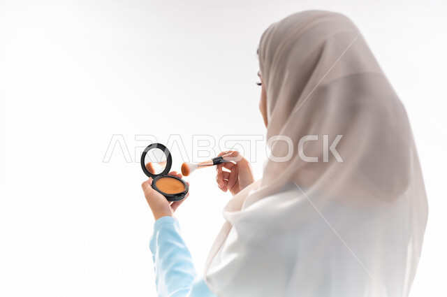 مفهوم الأنوثة والاهتمام بالجمال والبشرة والمظهر الخارجي, خبيرة سعودية لمستحضرات التجميل النسائية، بورتريه مقرب لإمرأة عربية خليجية عمانية ترتدي العباءة والحجاب، التسويق لمنتجات الميك اب، خلفية بيضاء