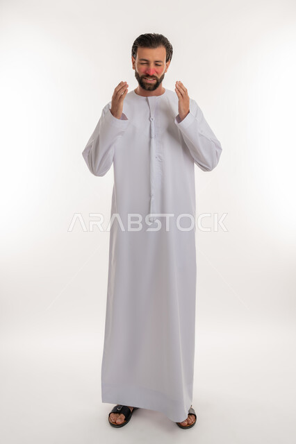 الكحة والتهاب الحلق، الإصابة بالأنفلونزا ونزلات البرد، الشعور بالارهاق والتعب الشديد، الحاجة للعلاج وزيارة الطبيب، بورتريه لرجل عربي خليجي اماراتي يرتدي الكندورة يرفع يديه بالسعال بايماءات الازعاج من المرض, صورة لكامل الجسم، خلفية بيضاء