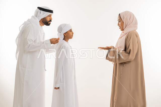 Intimacy, love and family cohesion, discussions and dialogues between family members, maintaining family stability, parents taking care of their children and caring for them, close-up portrait of an Arab Gulf Emirati family exchanging news and conversations, white background