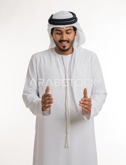 The concept of elegance and attention to external appearance, containing and holding an item, a close-up portrait of an Arab Gulf Emirati man wearing a kandora and turban, opening his hands to display three-dimensional holographic elements, white background.